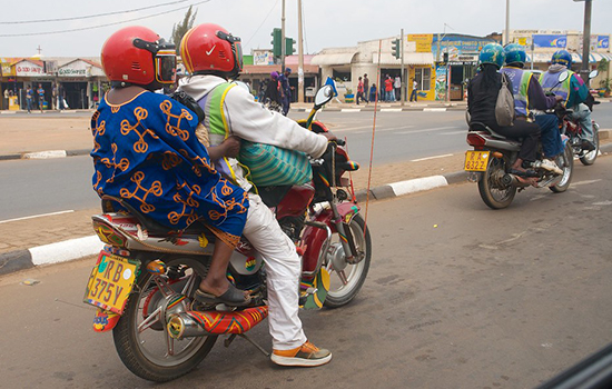 Two motorbikes, each carrying two people