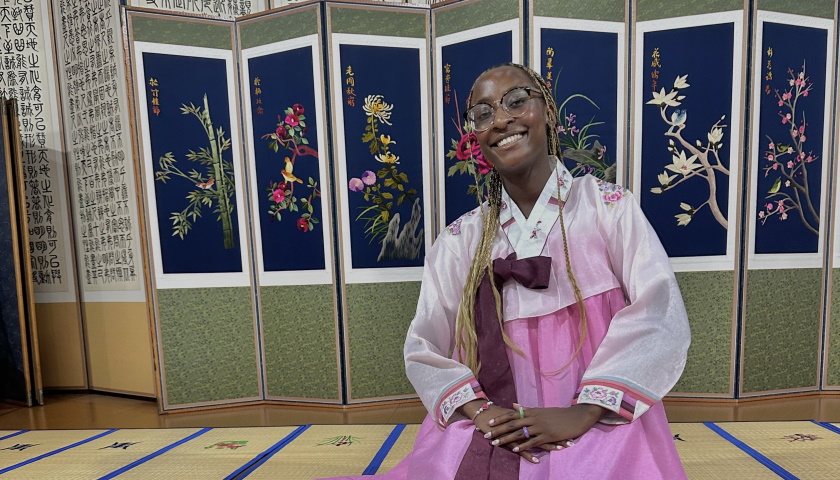Stephanie Bulega-Nasuna sits while wearing traditional South Korean attire