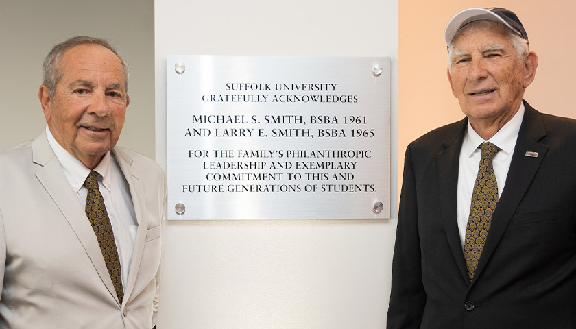 Michael and Larry Smith stand beside the Smith Commons plaque thanking them for their leadership philanthropy
