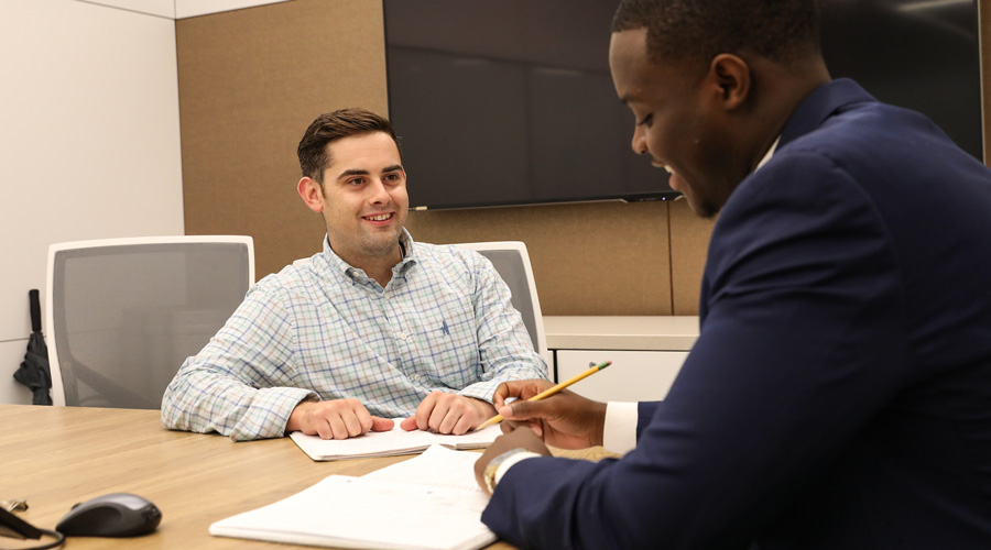 A Suffolk alumni meets with his Suffolk mentee. 