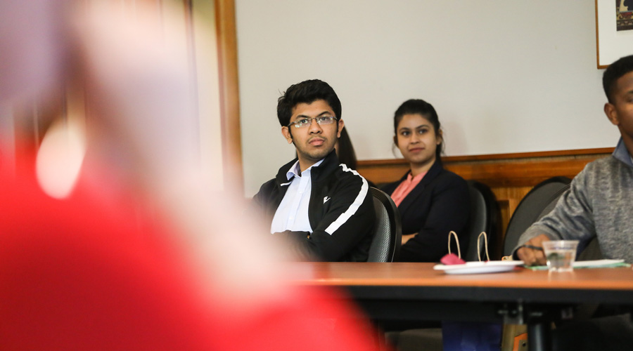 A Suffolk student listening to a speaker during a presentation.