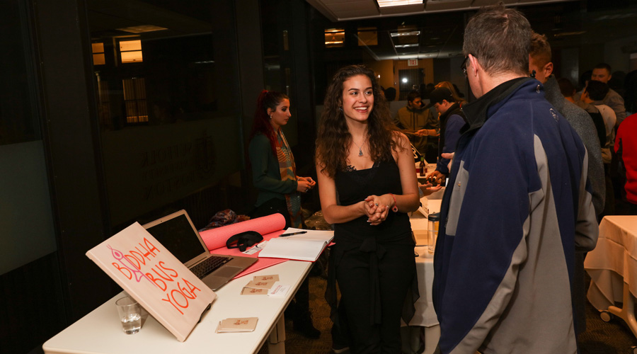 A Suffolk student presents her start-up company concept at an event.