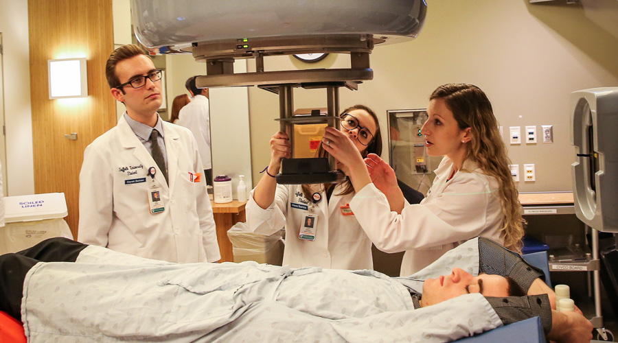 Suffolk radiation therapy students demo equipment at Mass. General Hospital.