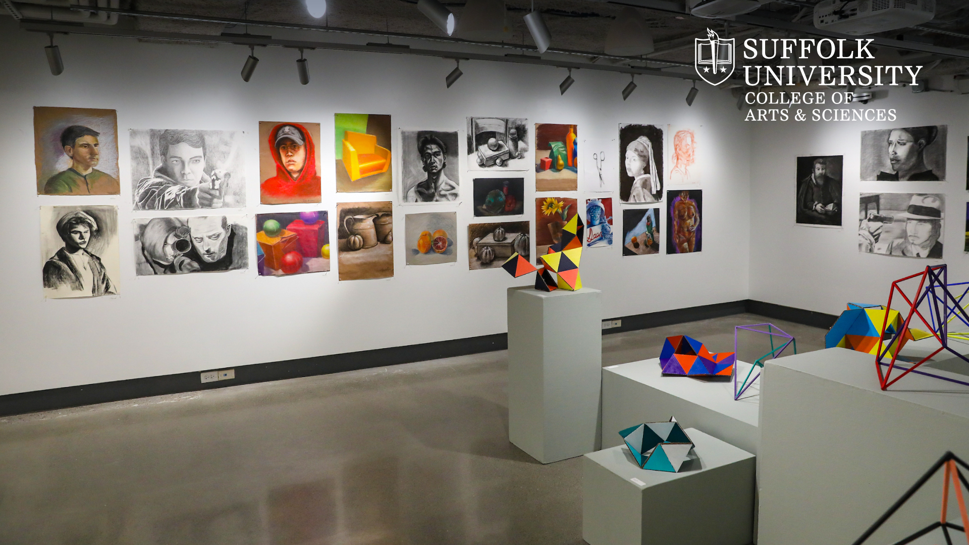 Student artwork on display in Suffolk's art gallery with the CAS logo in the top corner