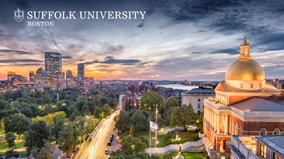 Sunset over Boston's Back Bay and the Massachusetts State House with the Suffolk University logo in the top corner