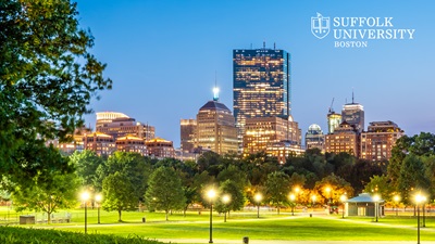 Boston Common with Back Bay in the background at twilight in the summer with the Suffolk University logo in the top corner