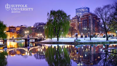 Snow blanketing Boston Public Garden at twilight  with the Suffolk University logo in the top corner