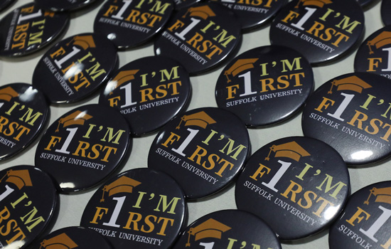 First-generation student buttons laid on out a table at an event.