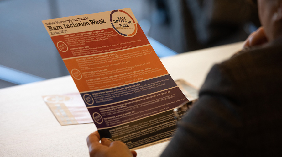 An attendee of Ram Inclusion Week looks over the week's itinerary.