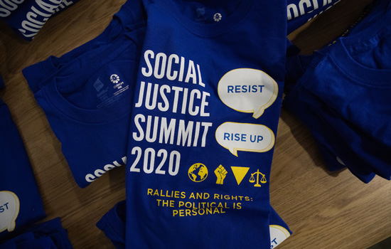 Social Justice Summit t-shirts on a table at the event.