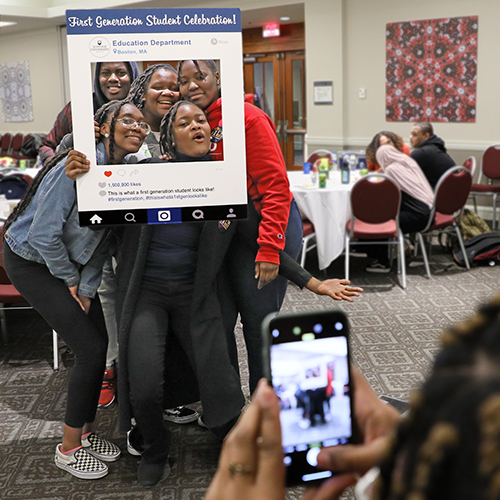 Five Suffolk First-Generation students pose together for a social media photo after an event