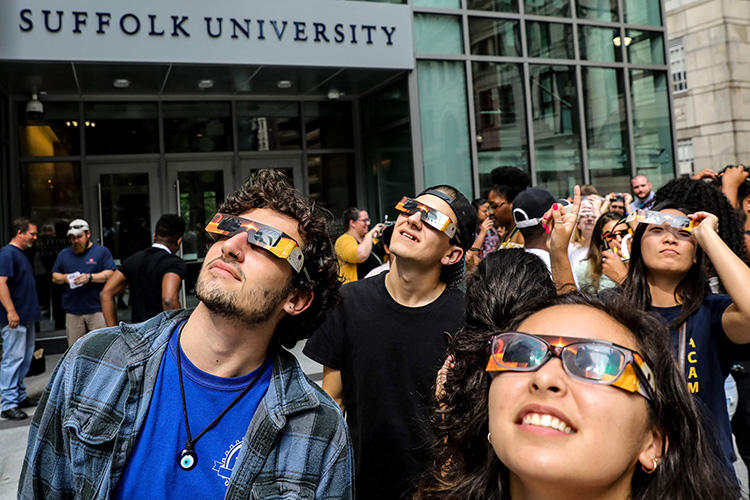 Suffolk University students observe the solar eclipse with eclipse glasses.