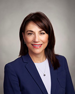 Portrait of Trustee Jane Mancini, smiling in blue blazer