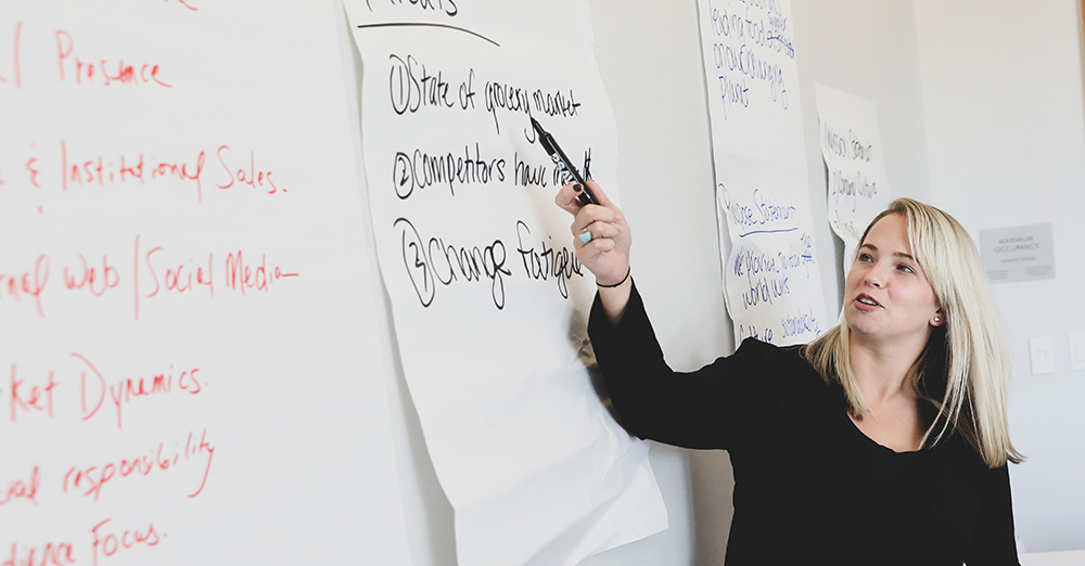 Suffolk students have a discussion around a classroom table.