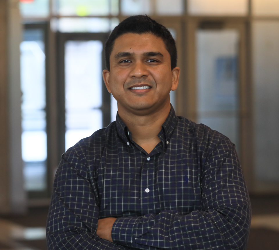 Faculty Kaushik Ghosh smiling in dark shirt