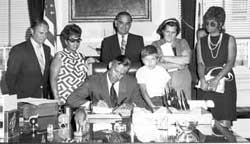 State Senator Joe Moakley watches as Governor Frank Sargent signs the Massachusetts "Anti-Snob Zoning Law," 1969