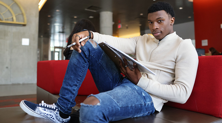 Suffolk student Ahmad studying in the Samia Academic Center.