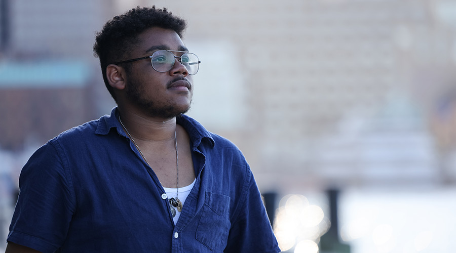Suffolk student Vinny poses for a photo on Fan Pier.