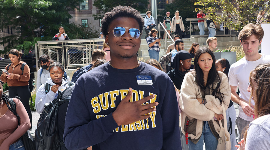 Suffolk student takes a photo during the Involvement Fair on Roemer Plaza.
