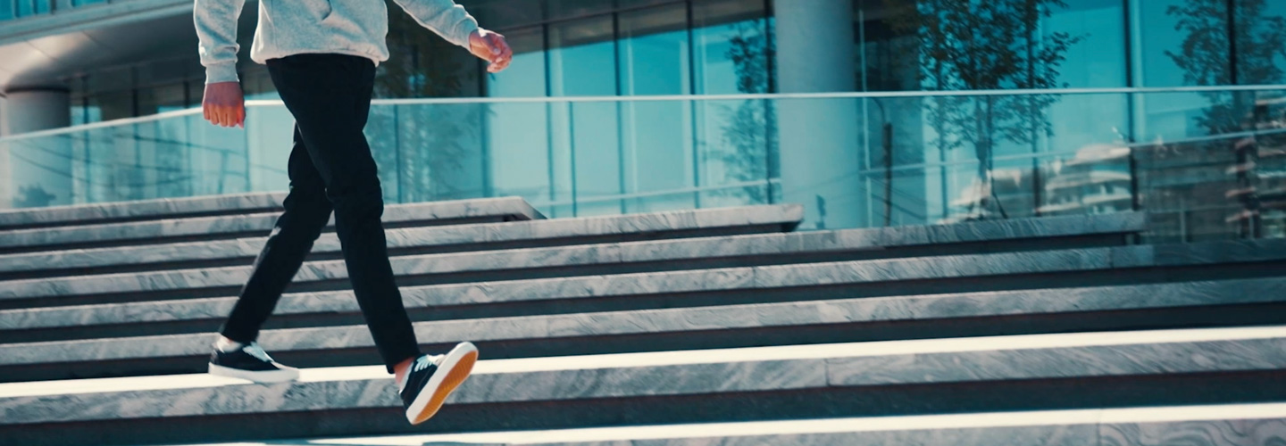 Student walking forward down stairs.