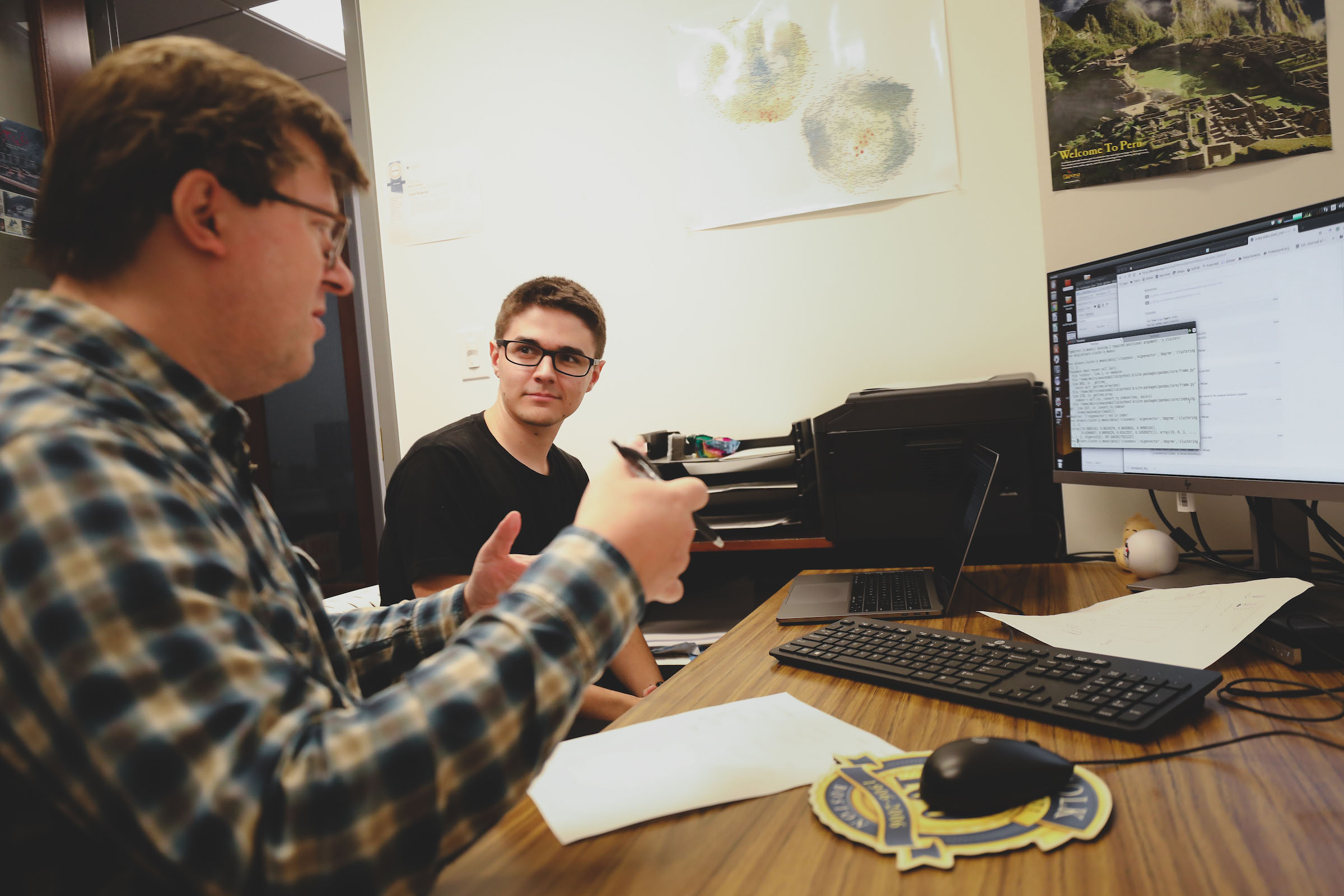 Teacher and student in front of a computer