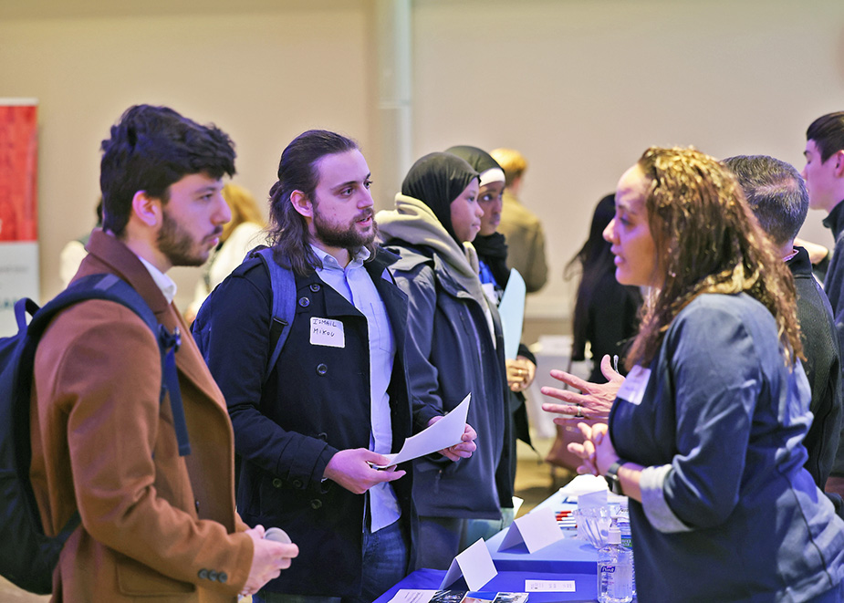 Suffolk students speak with recruiters at a networking event held on campus.