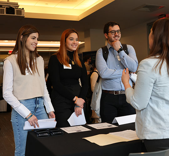 Students meeting with employers at a career fair