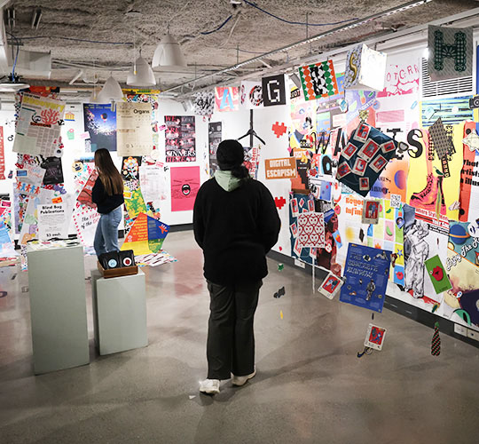 Student walks through the Art Gallery looking at the exhibition