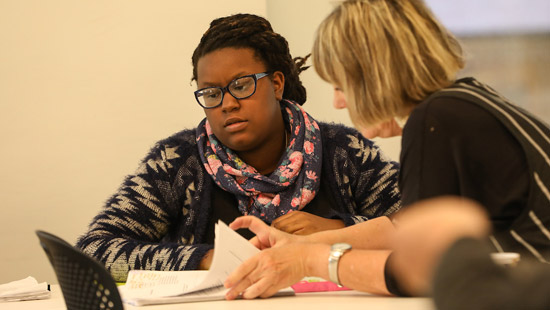 Student working with professor in playwriting class