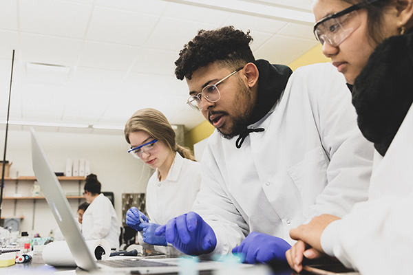 Students working in a lab wearing protective gear