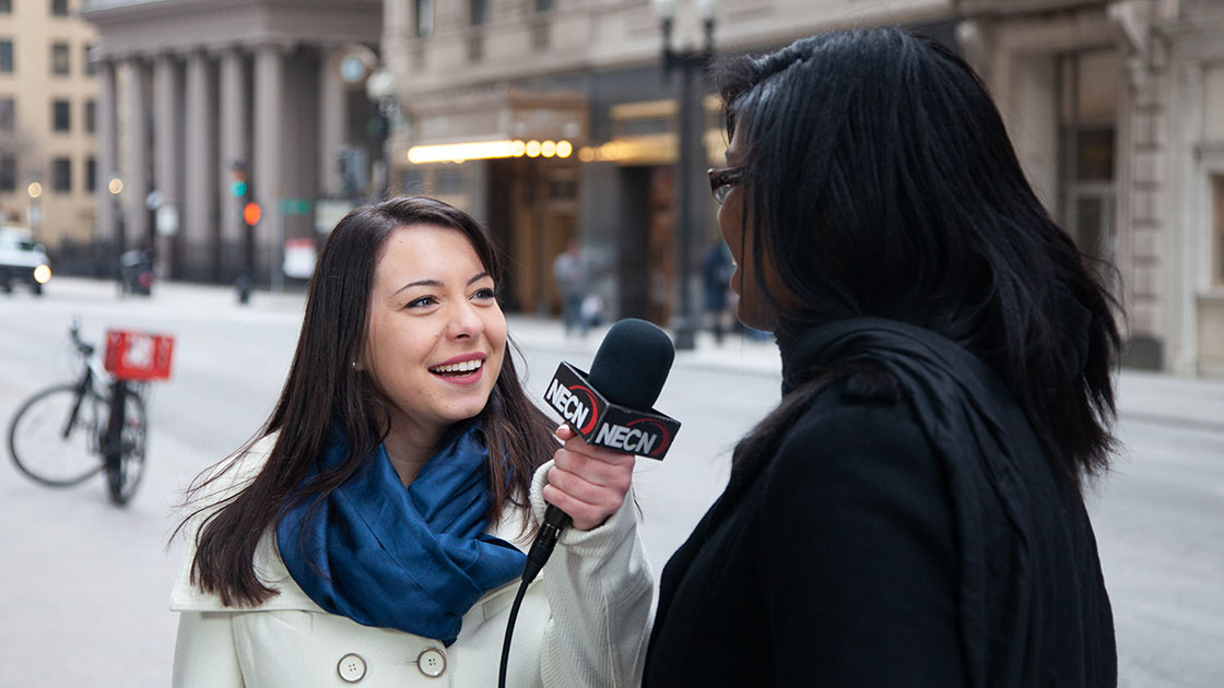 Student interviews a woman on the street