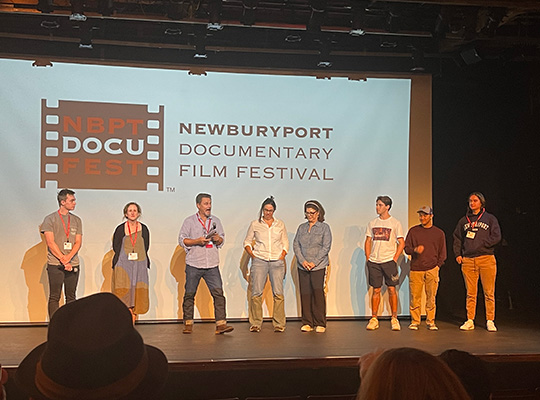 Suffolk University students stand on stage at the Newburyport Film Festival.
