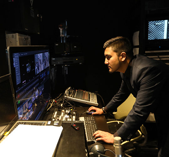 Student using production console in studio