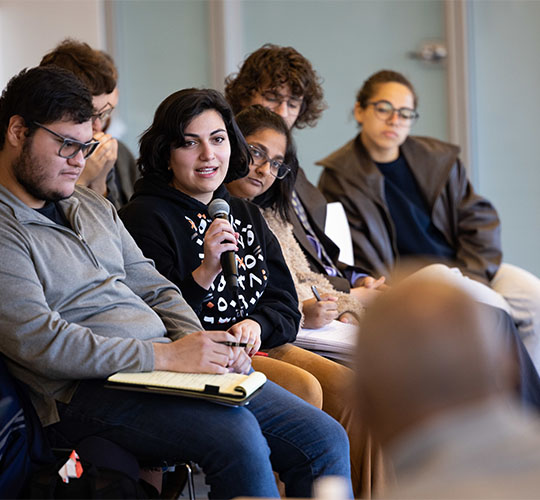 Audience member asking a question at a public forum