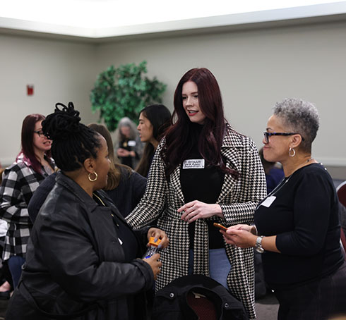 Three women talk at the Decarcerating Women Today event