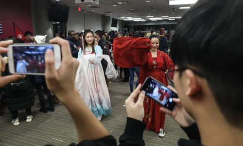 Two Suffolk students from Asia dance in traditional dress during Suffolk's International Night.