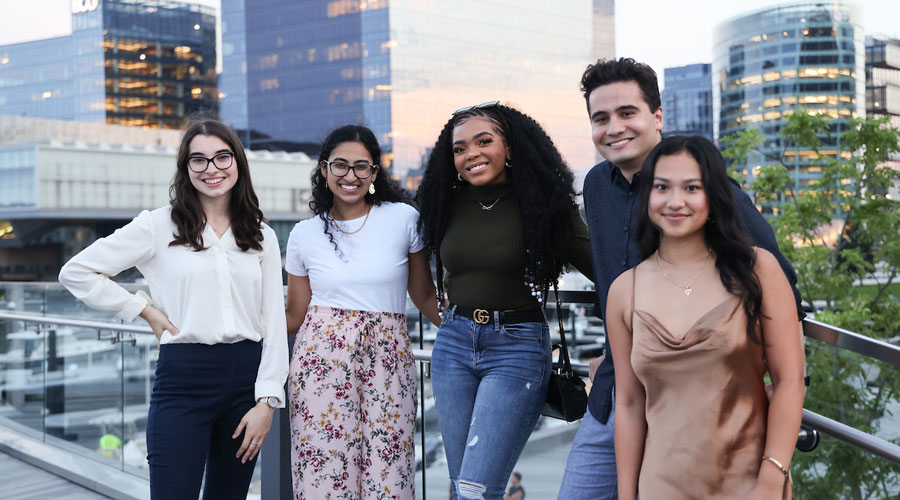 A group of Suffolk students pose for a portrait in Fort Point, Boston.