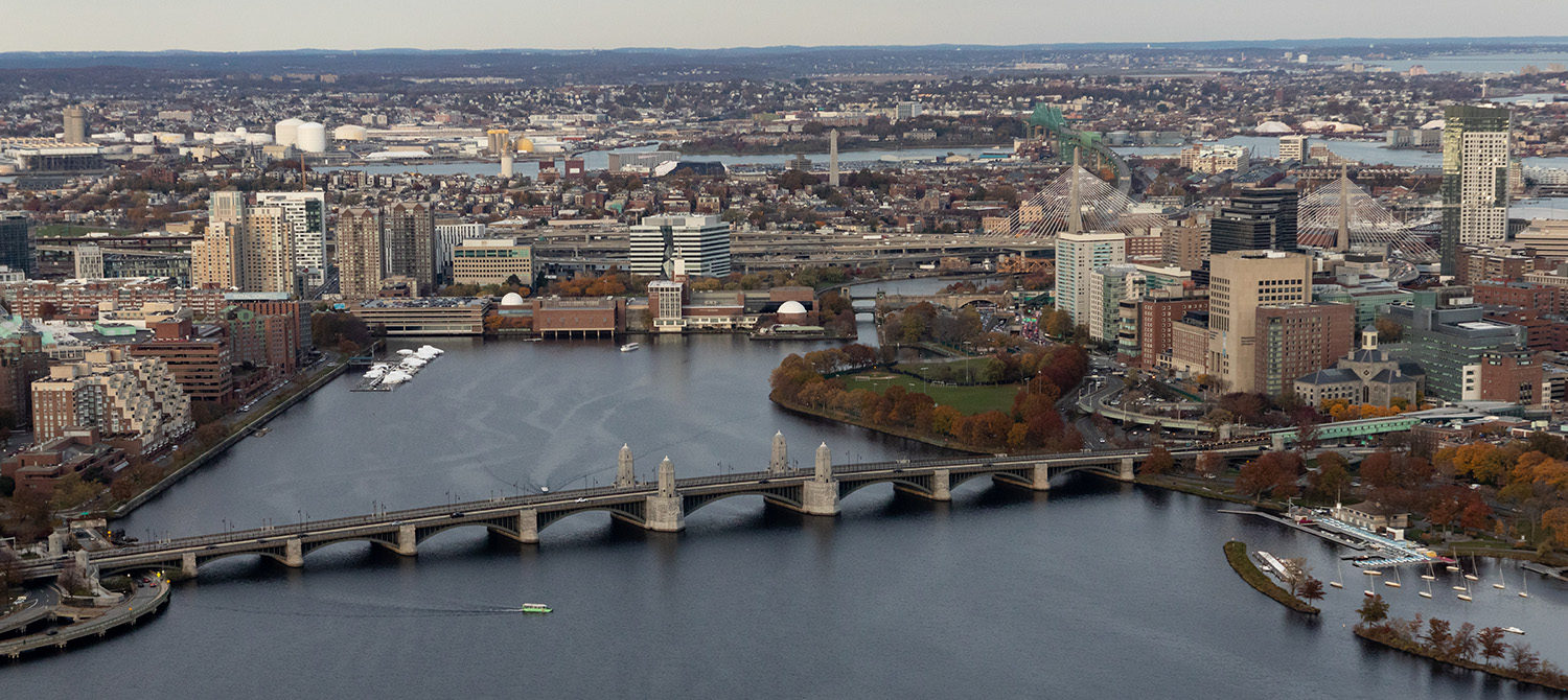 An aerial image of Boston and Cambridge, showing bridges spanning the Charles River.