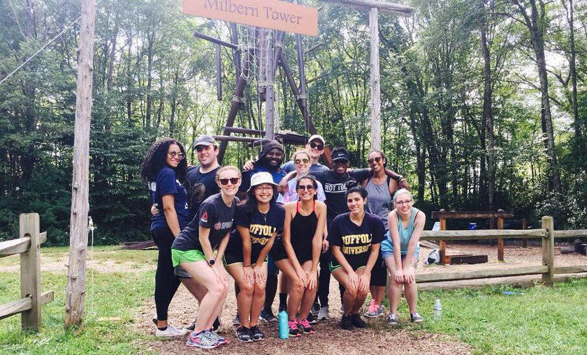 Brianna Vieira posing with classmates at an obstacle course.