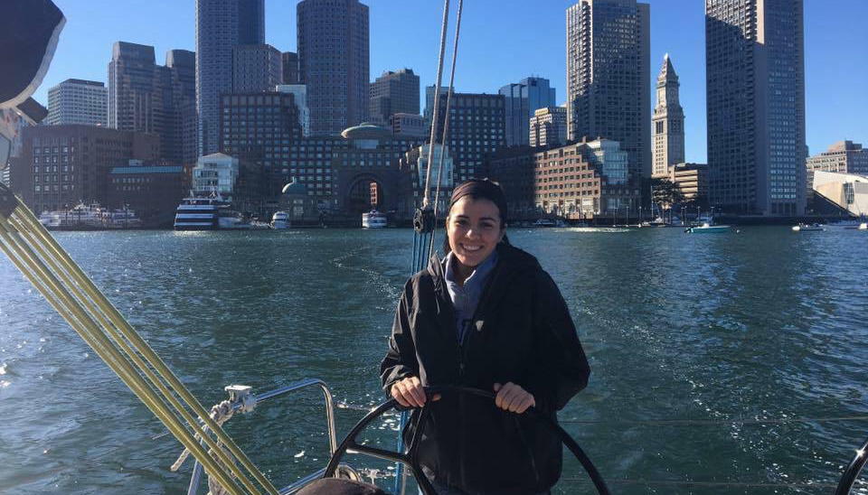 Brianna Vieira sailing a boat on the Boston Harbor