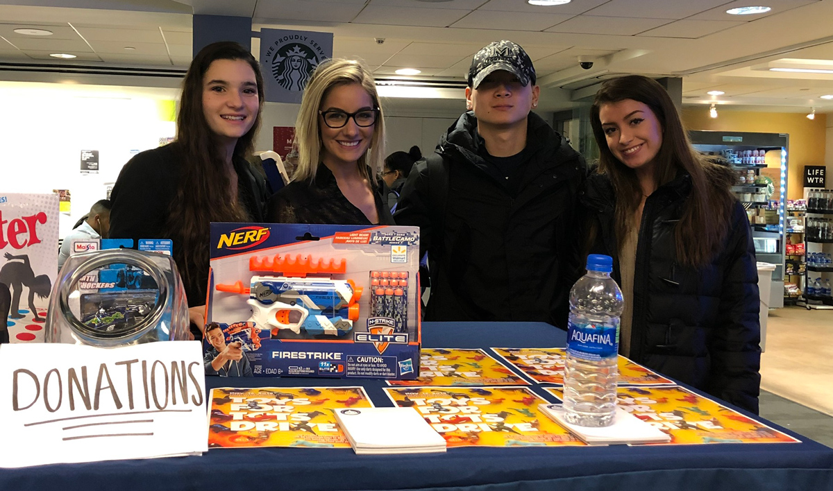 Dan Redznak standing with fellow classmates collecting donations for charity.