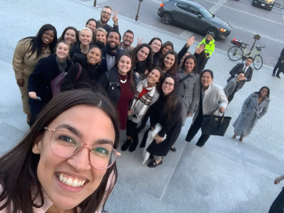 Suffolk student Gabriela Soto Cotto poses with her classmates and US Rep. Alexandria Ocasio-Cortez.