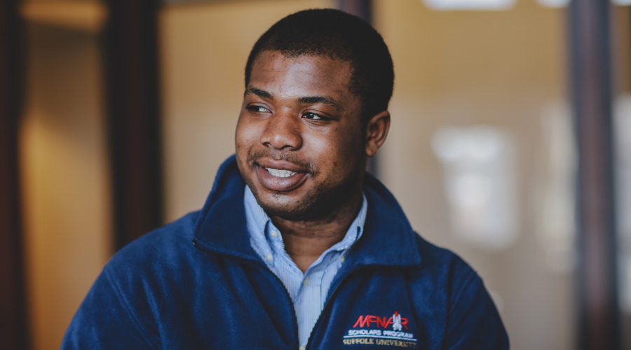 Suffolk student Isaac Boateng poses for a portrait on campus.