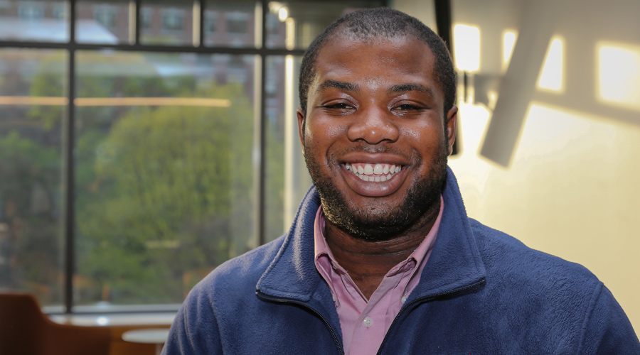 Suffolk student Isaac Boateng poses for a portrait on campus.