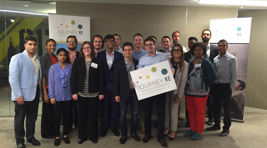 Vincent LePore poses for a picture with a group of participants in the Hanover Re headquarters in Germany.