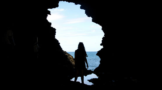 A Suffolk Student Standing in a Cavern in Barbados