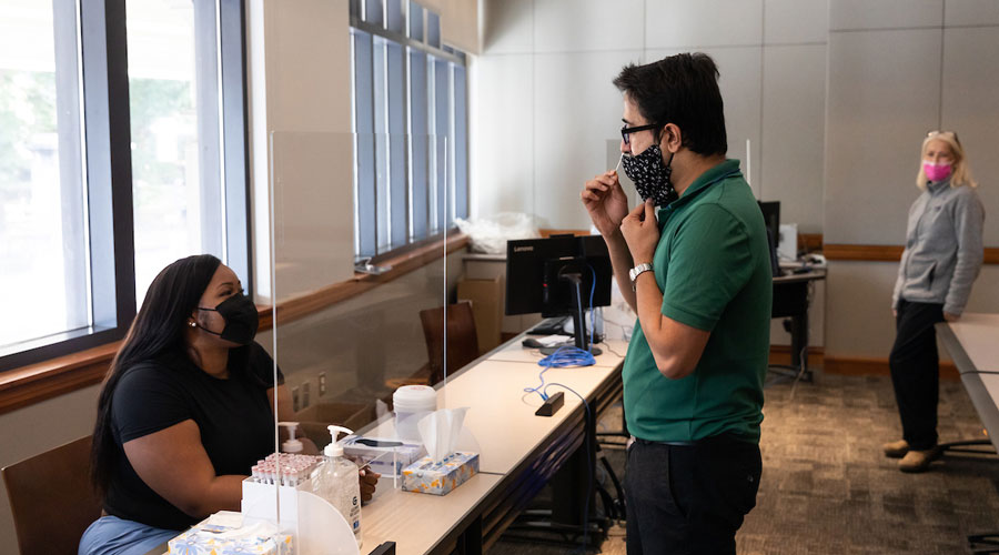 Suffolk staff member taking a Covid test at an on-campus testing facility.