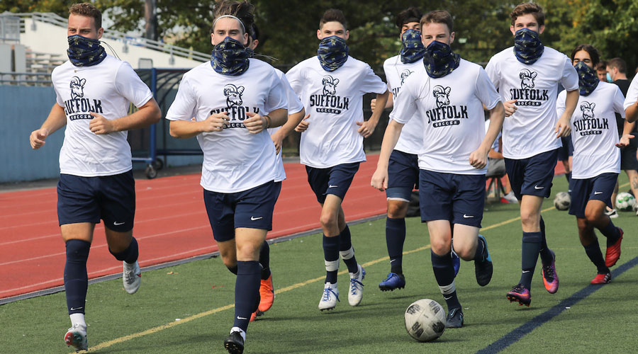 The Suffolk men's soccer team practices while wearing masks.