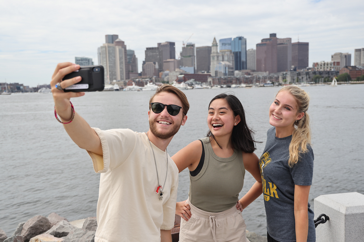 Suffolk students pose for a selfie on the East Boston waterfront.