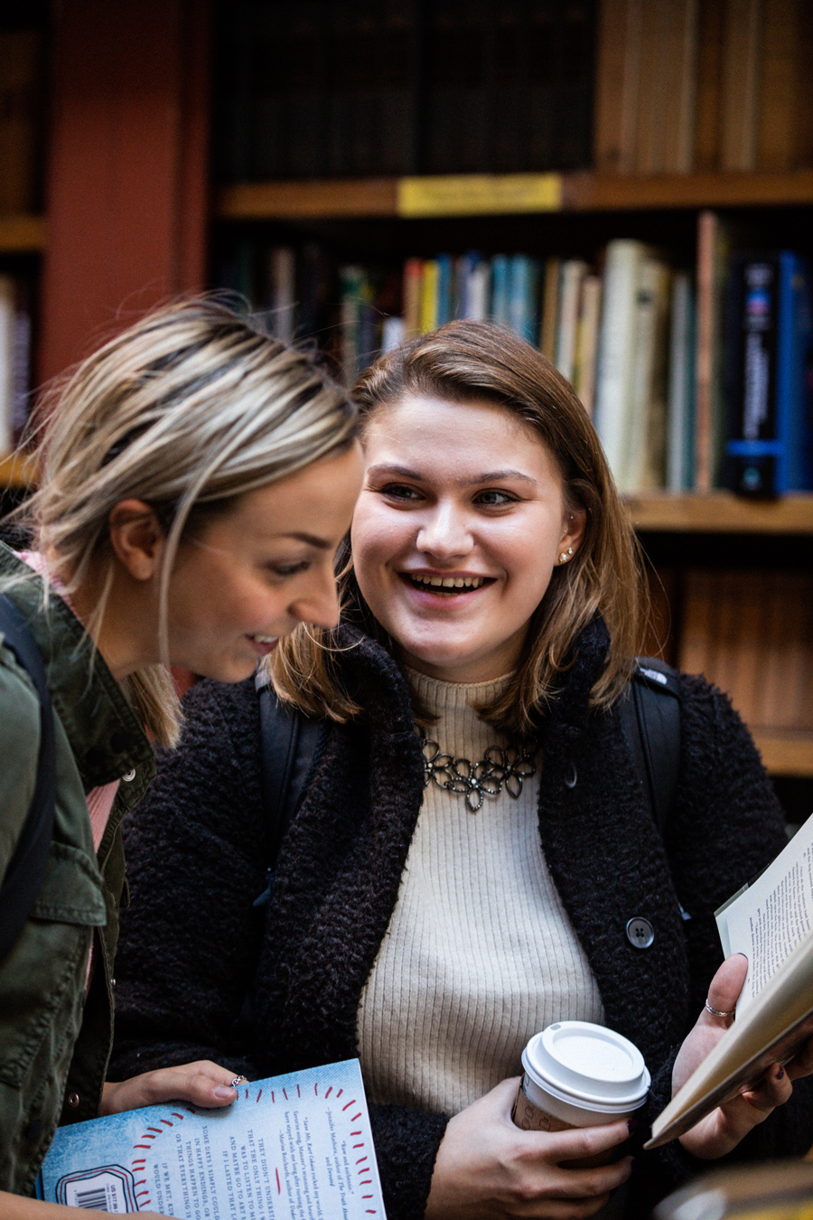 Christina Rayball sharing a book with another student at the Brattle Book Shop on West Street.